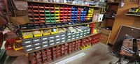 Wide view showing shelving unit, coloured bins, metal drawers and some fasteners