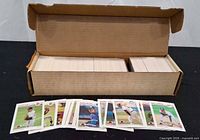 Open corrugated box showing several hundred baseball cards with selection of fronts displayed