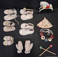 Overview of shoes, mittens, and toys on black background