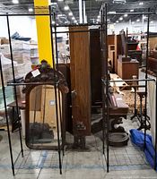 Front view of black metal clothes rack showing wire frame and hanging section