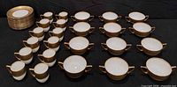 Full set laid out showing plates, cups and bowls
