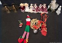 Full lot showing brass angels, dolls, plush elf, garland, bells and tassels