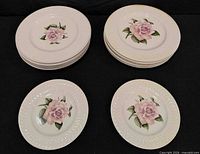 Stacks of plates showing size difference and rose motif