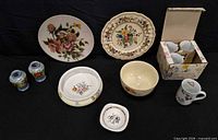 Group shot of entire lot showing plates, mugs, bowl, basin, shakers, trinket dish