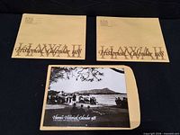 Two sealed kraft envelopes and one opened Hawaii Historical Calendar 1988 laid out