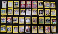 Overview of numerous stacks of yellow-border baseball cards arranged in rows