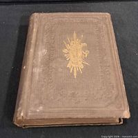 Front cover showing embossed border and central gilt design