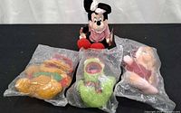 All four plush toys displayed; Minnie Mouse unbagged, three others sealed