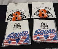 Front view showing all four T-shirts, two Orioles design, two World Cup design