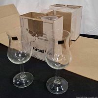 Two glasses in front, original carton with remaining glasses behind