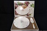 Open presentation box showing floral cake plate and server