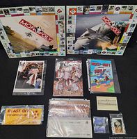 Two Monopoly boards, sports and comic items laid out