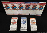 Front view of seven sealed packs and three opened sets