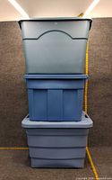Three stacked blue plastic totes showing overall sizes