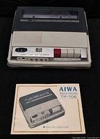 Top view of AIWA TP-706 recorder with instruction booklet