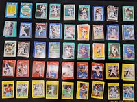 Overall view showing sealed Toys R Us set and multiple stacks of assorted baseball cards