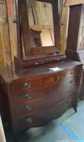 Front view of four-drawer wooden dresser with separate tilting vanity mirror on top