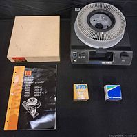 Full lot showing projector, tray, tray box, manual and two lamp boxes
