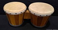 front view of wooden attached bongos