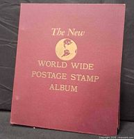 Front cover of maroon album showing title and globe graphic