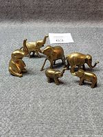 All six brass elephant figurines grouped together