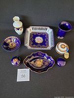 All seven cobalt blue Limoges pieces laid out