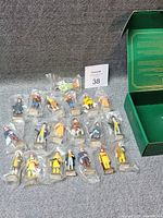 Group shot of sealed figurines laid out with box