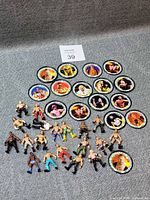 Group shot of all figurines and medallions laid out on fabric background