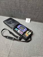 Open carry case showing console and five cartridges