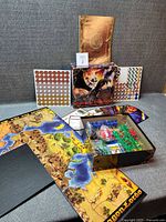 Opened box showing board, rulebook, punchboards, plastic miniatures, cards