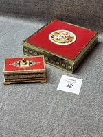 Both tin boxes closed showing size difference and decoration