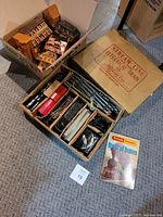 Boxed train set with interior compartments holding train cars, track, accessories and booklet