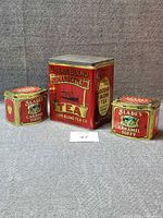 Front view of three tins showing graphics