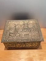 Top view showing embossed nautical scene, overall box design