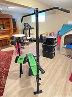 Full view of bench with lat tower, barbell and plates