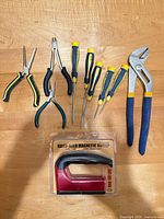 Front view of all tools laid out including packaged magnetic sweep, pliers and screwdrivers