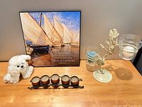 All items grouped: framed print, two candle holders, plush toy