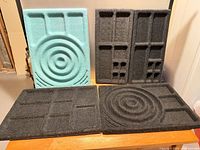 Front view of five felt drawer inserts showing layouts and colours