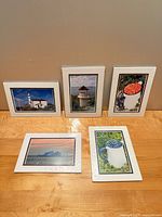 Front view showing all five matted postcards standing and lying