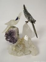 Three gemstone bird figurines on crystal bases grouped together