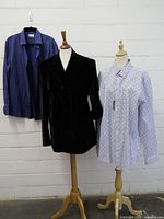 Overall view of blazer and two shirts on mannequins/hanger