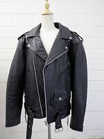 Front view of black leather motorcycle jacket on mannequin