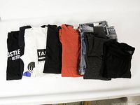 All eight folded garments laid out in one row