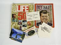 Front covers of both magazines plus postcards and booklet