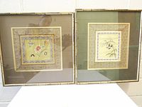 Both framed silk panels side by side front view
