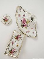 Inkwell tray with opening, separate lid, and rocker blotter top showing floral and gilt decoration