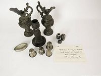Lot overview showing 2 ewers, candlestick, 2 shakers, 4 thimbles, oval dish