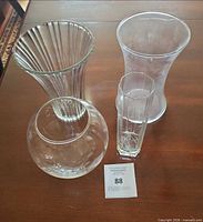 All four clear glass vases displayed on tabletop
