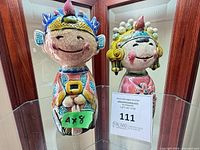 Front view of both ceramic figurines