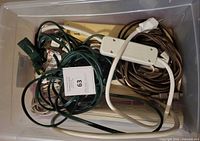 Overview of cords and power strips in storage bin